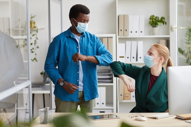 An image of a manager explaining the new sick leave policy to employees in an office setting, emphasizing transparency and open communication.