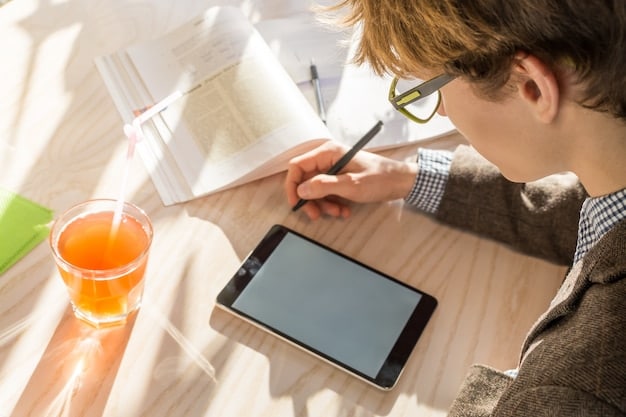 A person wearing glasses is diligently studying a tablet that highlights online curriculum. Surrounding them are sticky notes, textbooks and other accessories, showing that they are keen to study.