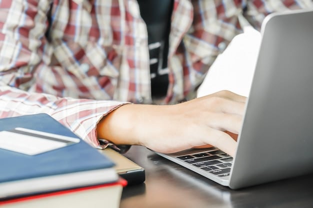 A close-up shot of a student's hands typing on a laptop, with the reflection of the college application essay prompt visible on the screen. The student appears focused and determined.