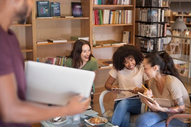 Students collaborating on a project at a table in the college library, surrounded by books and laptops.