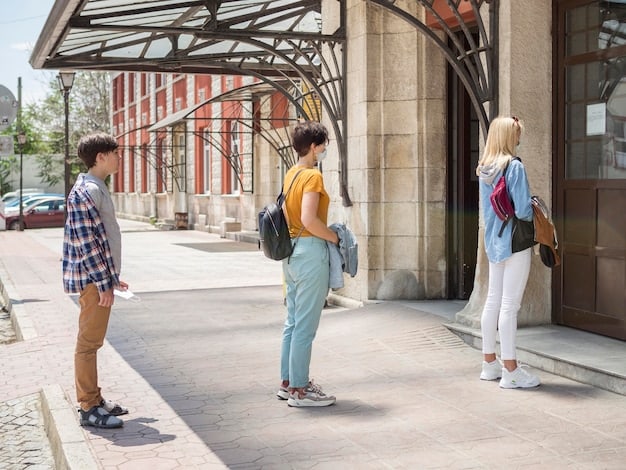 A student is walking on a college campus, surrounded by other students heading to classes. The atmosphere is lively and energetic, with students talking and laughing. The background shows a mix of historic and modern buildings, with trees and green spaces creating a welcoming environment.