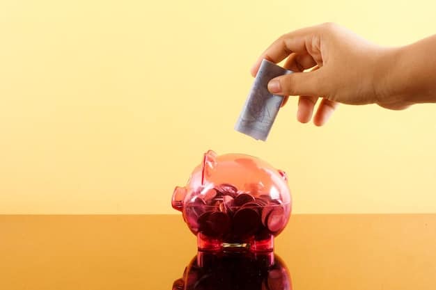 A close-up shot of a person's hand inserting money into a piggy bank labeled 
