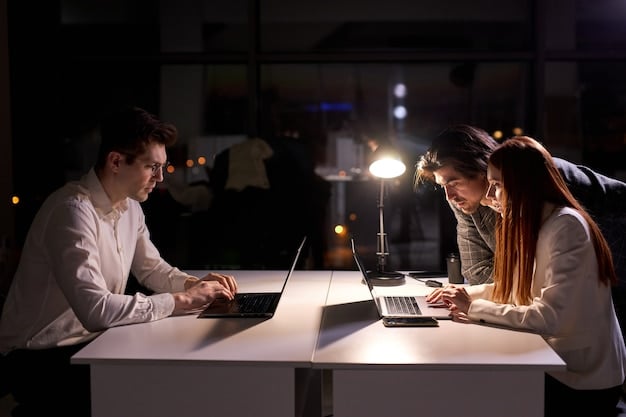 Two professionals sitting at a table, engaged in a negotiation, with papers and a laptop between them, illuminated by natural light from a nearby window and a professional desk lamp.