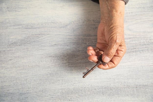 A close-up shot of a veteran's hand holding keys to a new home. The background is slightly blurred, showing a welcoming front porch and a 