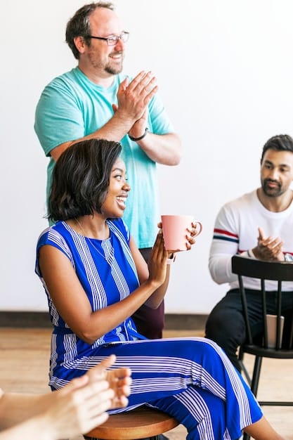 An image featuring a diverse group of people at a community meeting, discussing housing issues and support, with a sign in the background that reads 
