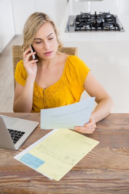 A person reviewing documents related to energy bills and eligibility requirements for assistance programs, with a laptop displaying an application form in the background. The image emphasizes the process of applying for and understanding the criteria of energy assistance for renters.