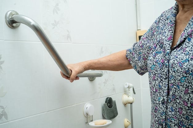 A close-up of a hand using a wheelchair-accessible kitchen sink with lever handles and knee space underneath.