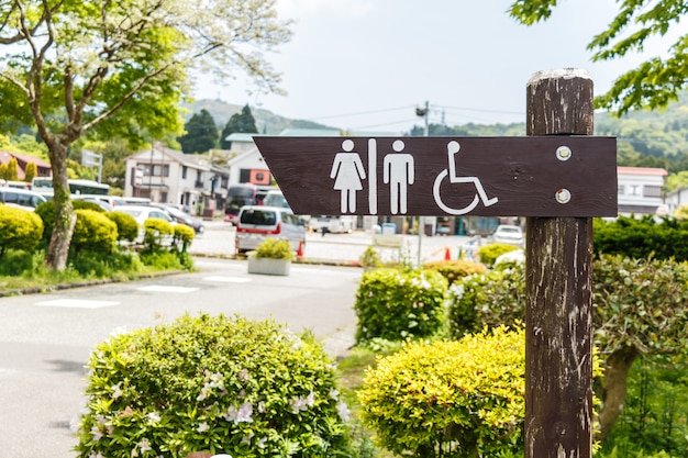 A community building with a sign indicating resources for people with disabilities, surrounded by accessible pathways and green spaces.