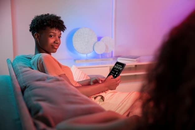 A person using a light therapy box in a bright, airy room. The setting is peaceful and modern, with plants and sunlight visible. The person looks relaxed, demonstrating the therapeutic use of light to combat seasonal depression.