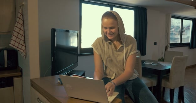 A person smiling while typing on a laptop, with a volunteer organization's website open on the screen. The setting is a modern co-working space, suggesting the individual is volunteering remotely.