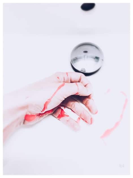 A close-up of an itemized medical bill with a magnifying glass hovering over specific line items. A hand is seen circling a charge with a red pen.